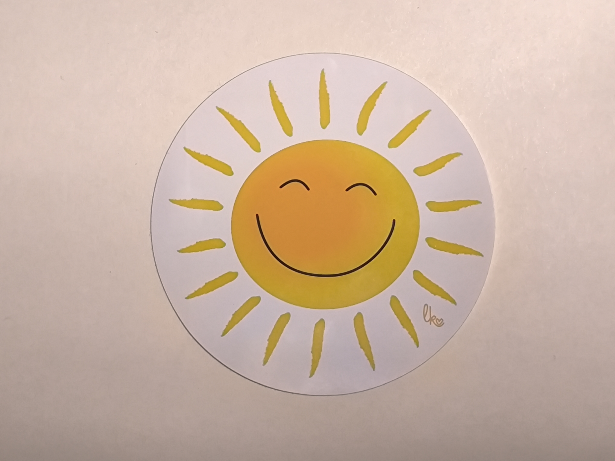 runder weißer Aufkleber mit lachender Sonne